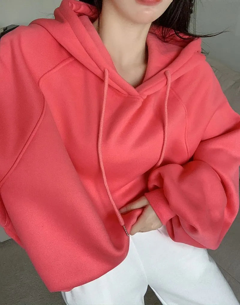 Watermelon red women's silk hooded sweater on hanger showing sleeveless design