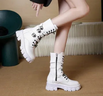 Women's black mid-calf knight boots with a metal buckle and side zipper on a chunky sole.