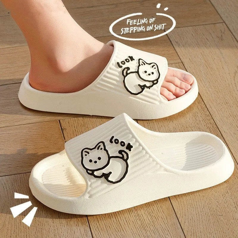 Green cat slippers with a thick EVA platform and non-slip sole on a wooden floor.