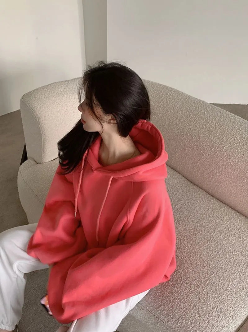 Watermelon red women's silk hooded sweater on hanger showing sleeveless design