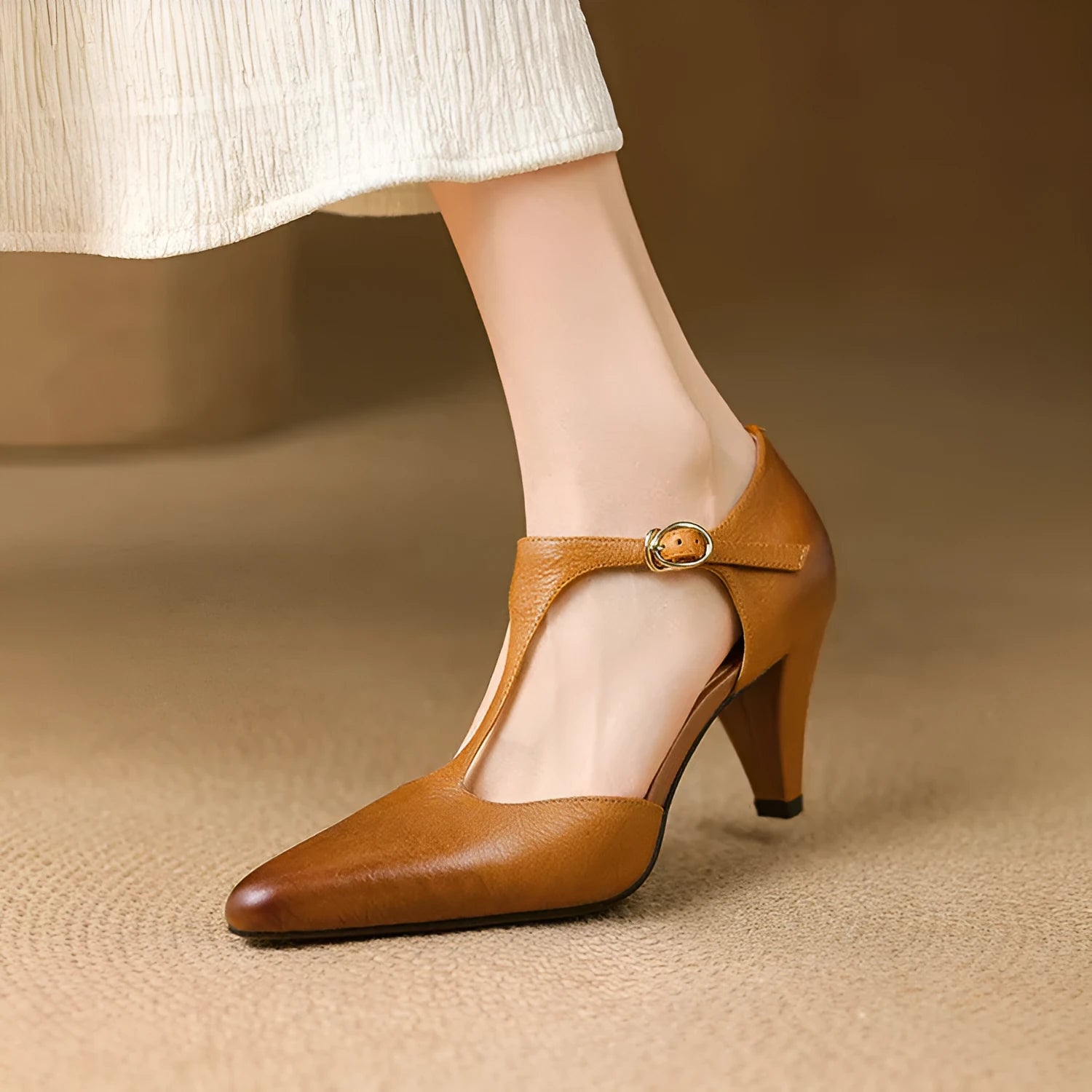 Brown retro women's T-strap closed toe sandals with a stout heel on a wooden surface.