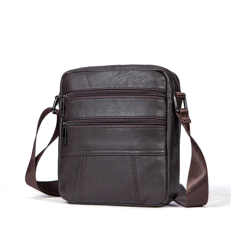 Men's black vintage genuine leather shoulder bag showing vertical square shape and front zipper.