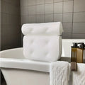 White bathtub pillow with suction cups on a 3D permeable surface, showing dimensions 37x34x10cm