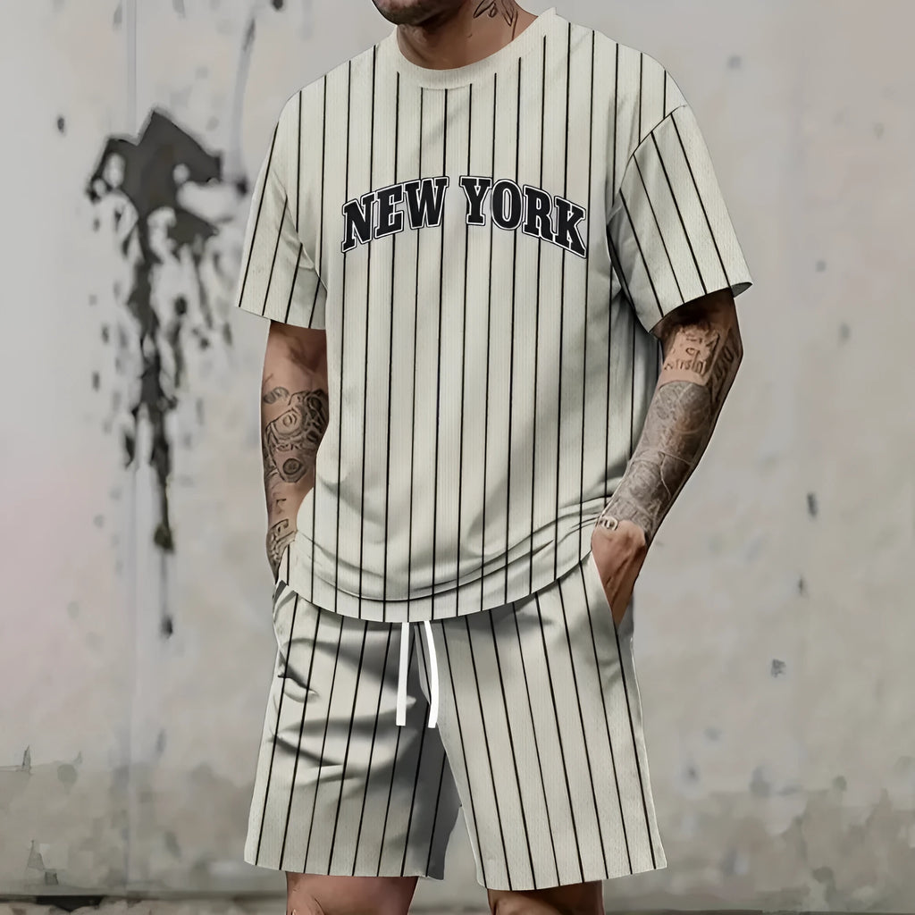 Man wearing a grey 3D printed letter short sleeve top and matching shorts suit set.