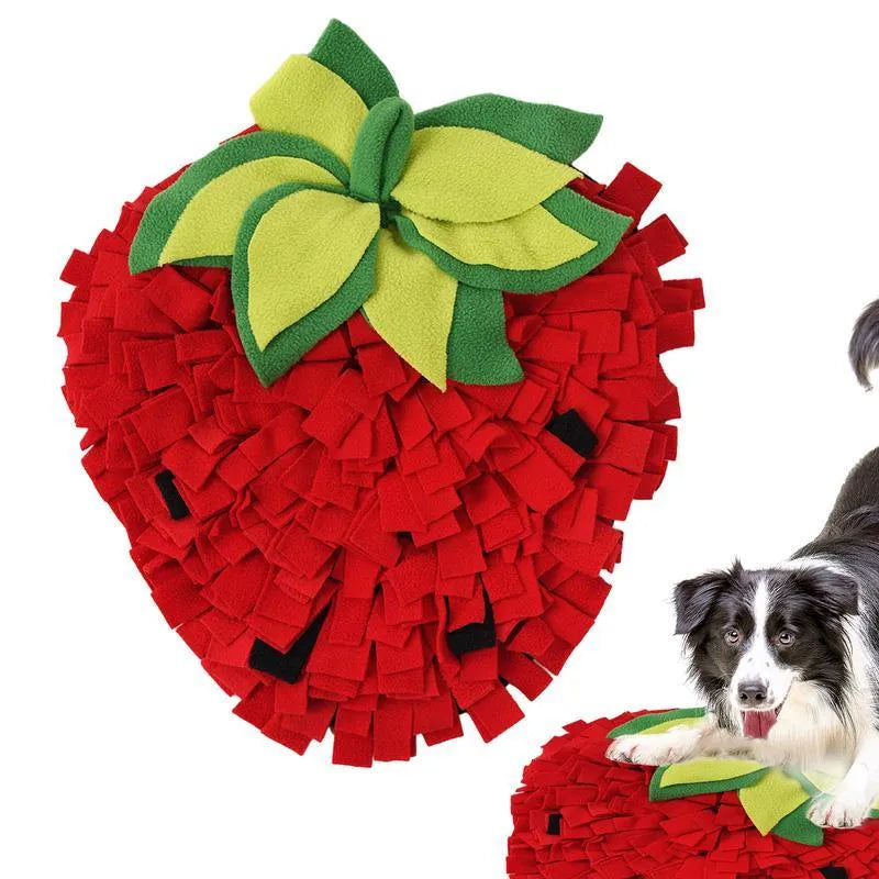 Red and green strawberry-shaped pet slow feeder snuffle mat on a floor