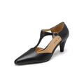 Brown retro women's T-strap closed toe sandals with a stout heel on a wooden surface.