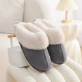 Women's brown plush indoor slippers with round toe, flat heel, and textured non-slip sole.