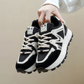 Women's black platform casual trainers with round toe and lace-up front on a white background.