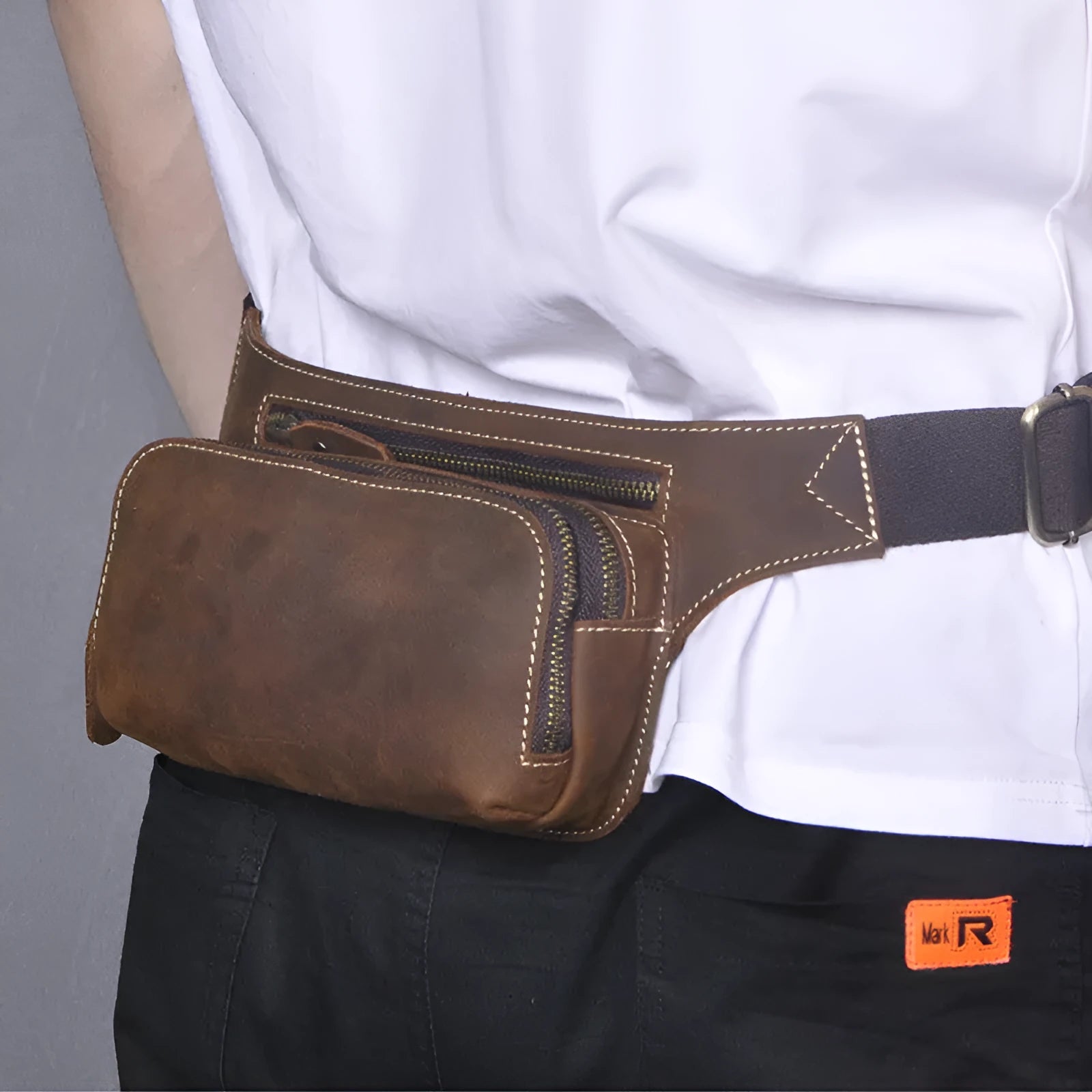 Brown men's cowhide sports waist bag shown with pull closure.