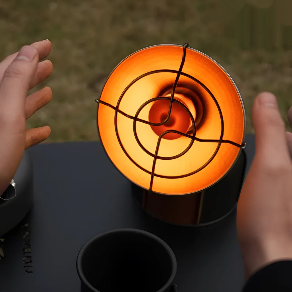 Black and orange portable outdoor heating stove with automatic press ignition for camping