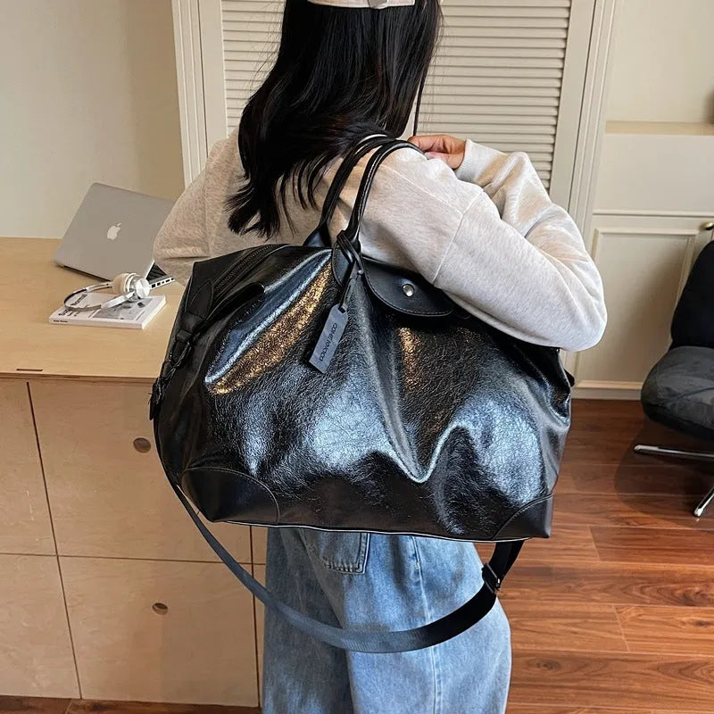 Large hand-carrying travel bag for women in black, capacity 36-55L, made from PU material with polyester lining