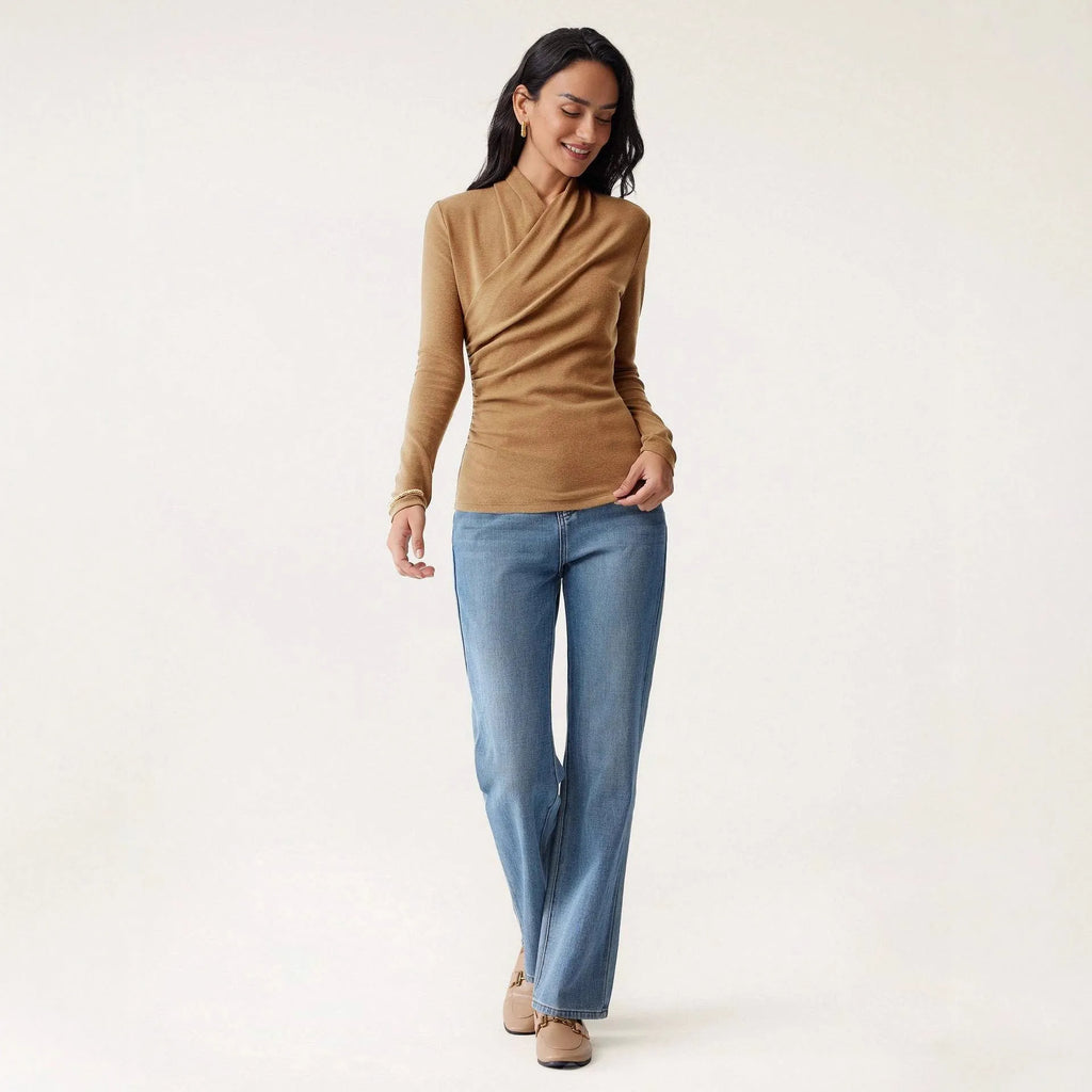 Camel coloured women's slim fit long sleeve pullover sweater on a hanger