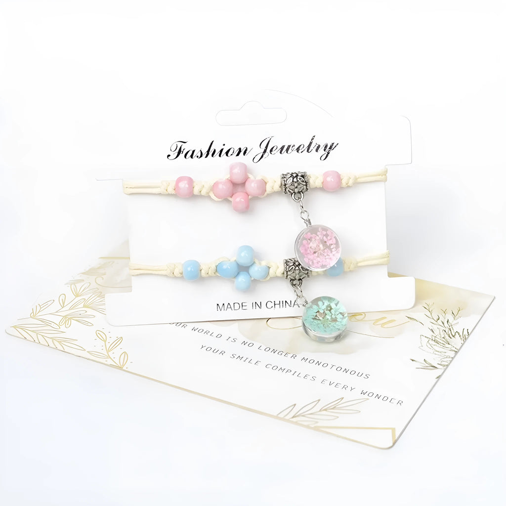 Women's glass bracelet with large beads containing real dried flowers, shown in blue colour.