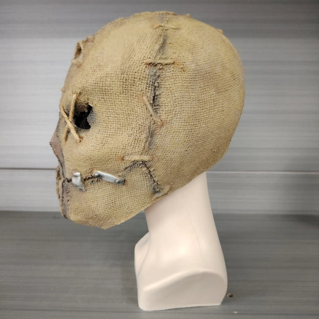 Latex horror mask with scar skull design worn as a full head cover for Halloween costumes