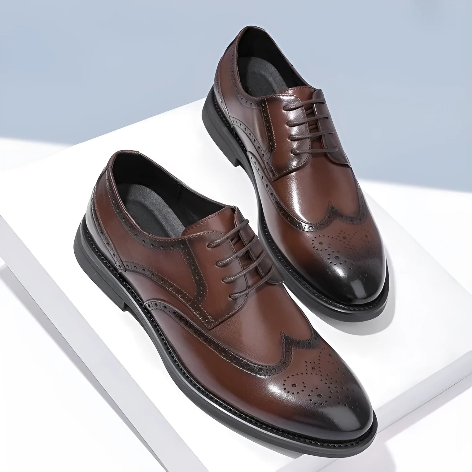 Men's black and brown brogue leather shoes for business occasions with traditional perforated detailing