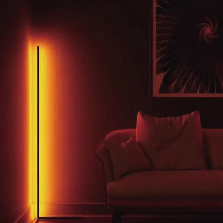 Black aluminium smart RGB floor lamp with silicone shade and remote control on wooden floor