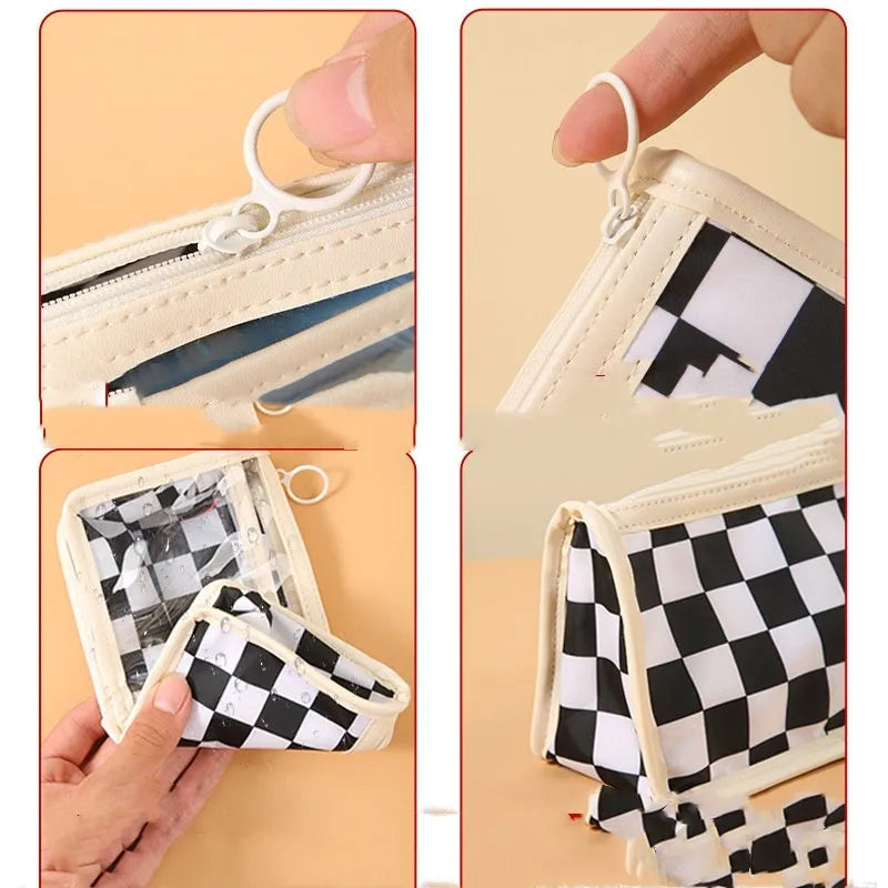 Large transparent PVC pencil case with a black and white chessboard grid pattern, showing pens inside.
