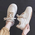 Women's pink and white low-top sneakers with a rubber sole, shown in sizes 35 to 40.
