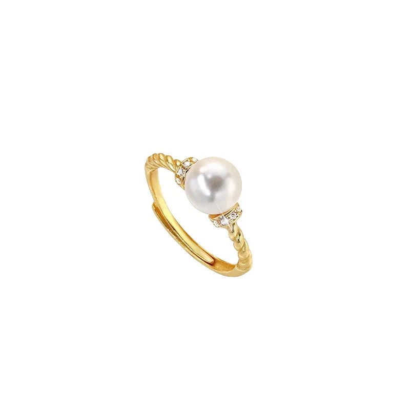 Adjustable antique-style copper ring with twisted geometric band and a pearl inlay centre.