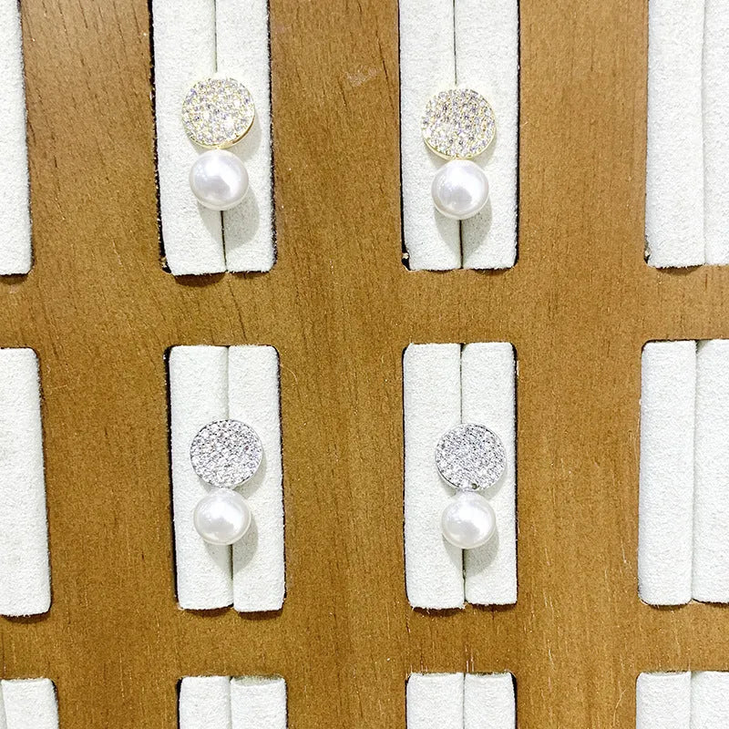 Round diamond studded pearl earrings in gold finish with secure stud fastening