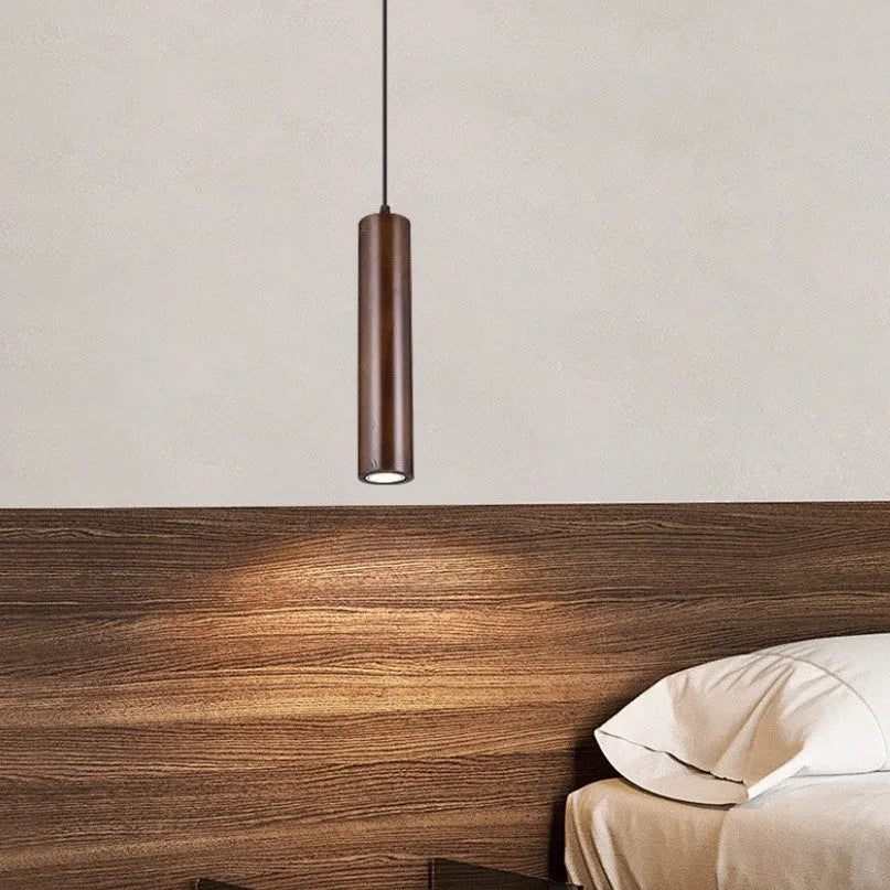 Solid wood Japanese style long chandelier with three warm light droplights in a modern bedroom
