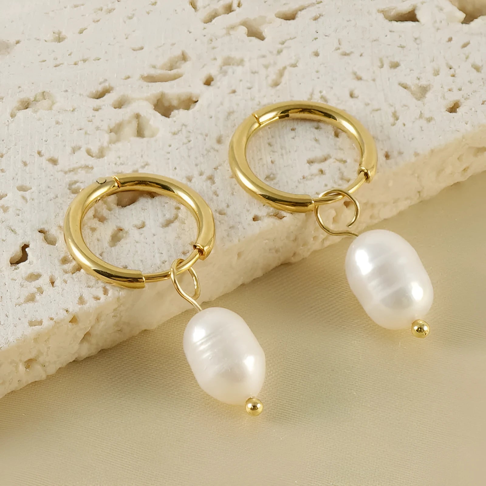 Geometric pearl earrings with gold electroplating on stainless steel and titanium steel construction