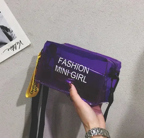 A transparent square jelly crossbody bag with a single adjustable shoulder strap.