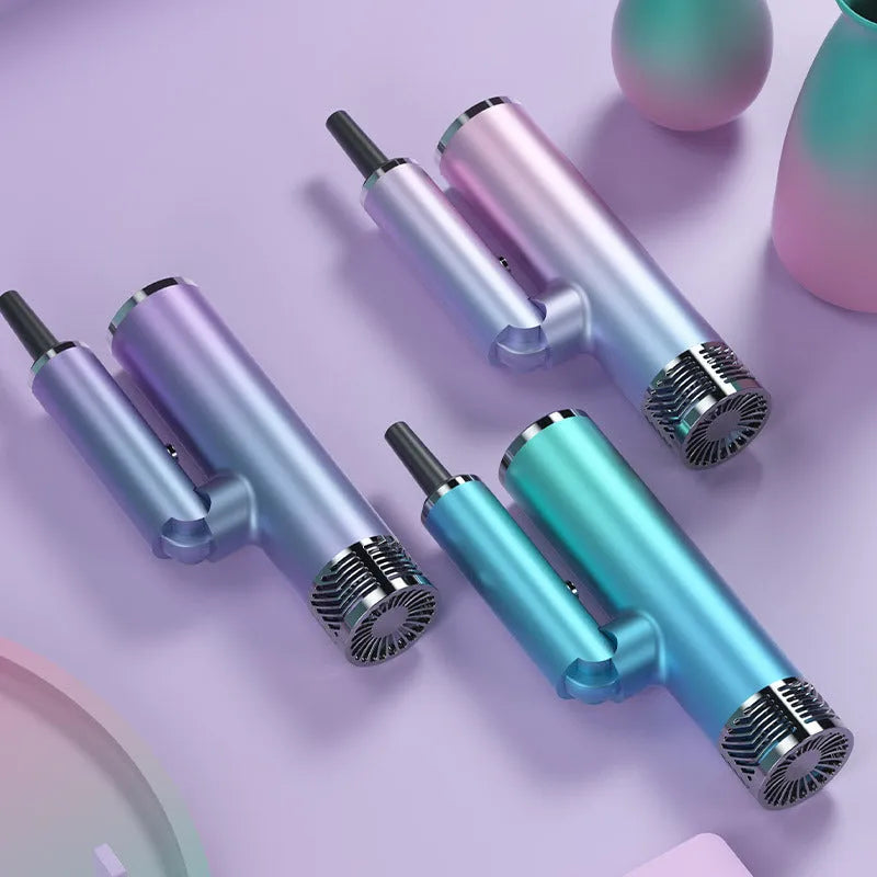 Green foldable hair dryer with collapsed handle next to a suitcase