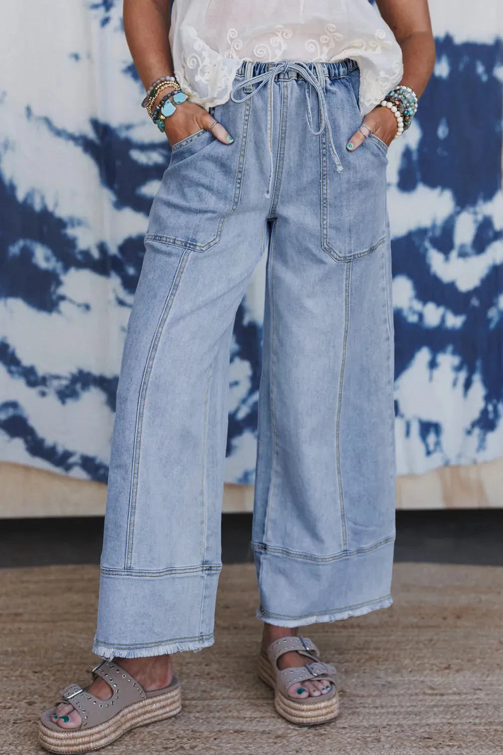 Beau Blue wide leg denim trousers with drawstring waist and raw hem detailing