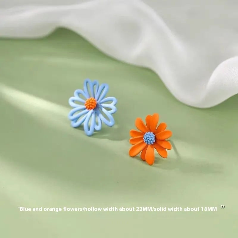 Cartoon flower stud earrings in alloy with two-tone blue and orange, white and green, or yellow and white colour combinations
