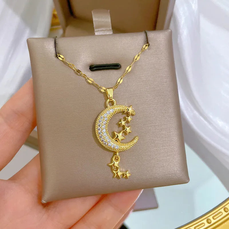 Moon pendant necklace with diamond accents and tassel on stainless steel chain