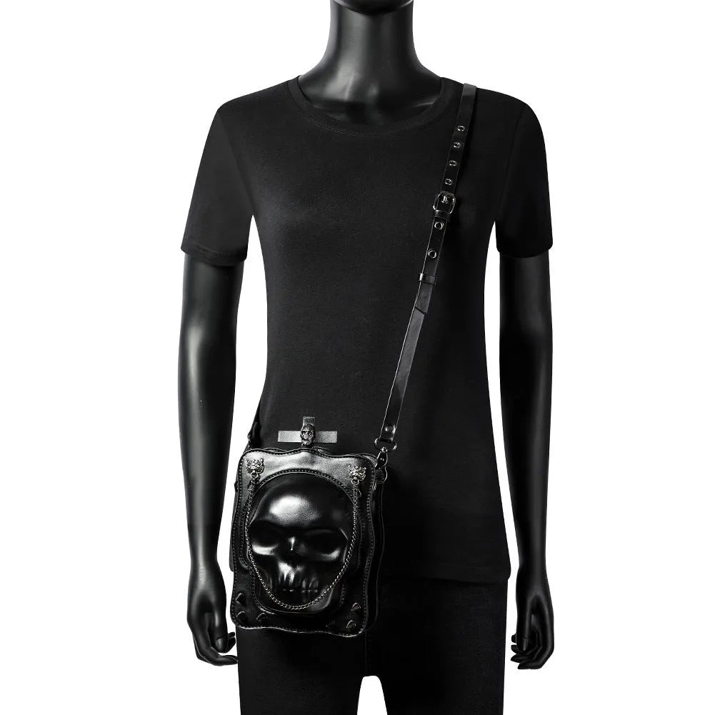 Black mini square crossbody bag with Halloween skull embossed design and chain accents