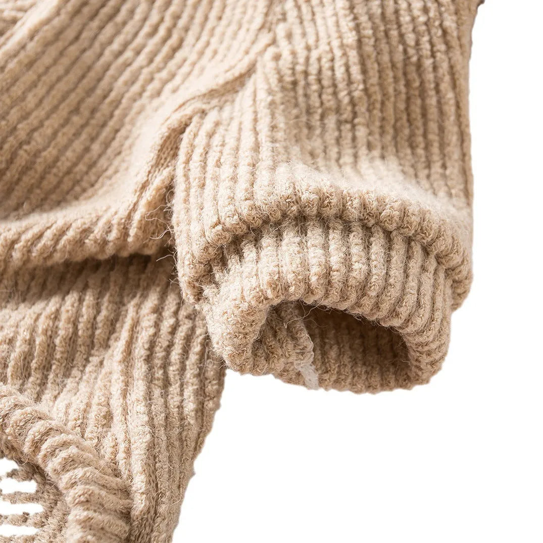 Brown knitted dog sweater on a small white dog, showing a casual pullover style.