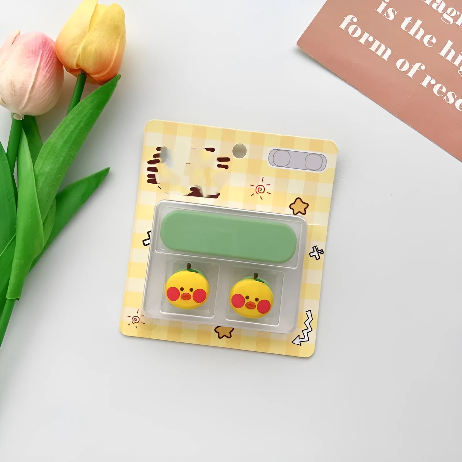 Cartoon magnetic protection data cable fixer in assorted colours on a desktop.