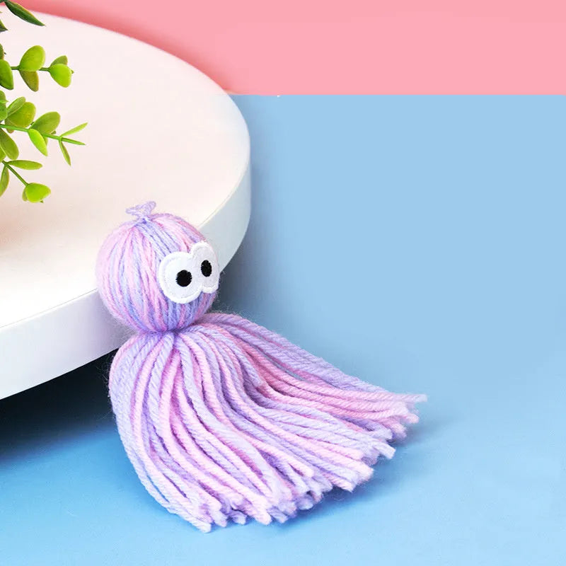 Bite-resistant wool cat ball toy in blue-grey, pink and blue, or pink and purple colour options.
