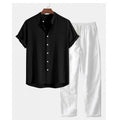 Man wearing a loose casual short-sleeve linen-look shirt and matching trousers in a solid colour.