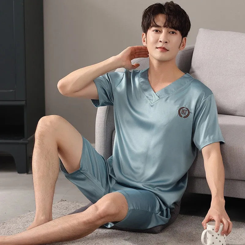 Man's loose blue ice silk short-sleeved pyjama shirt and matching shorts laid flat
