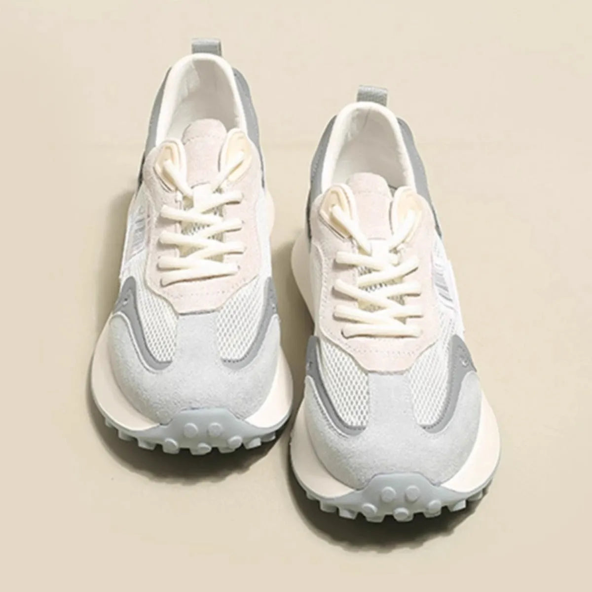 Women's pink and grey retro low-top sneaker with round toe and flat rubber sole.