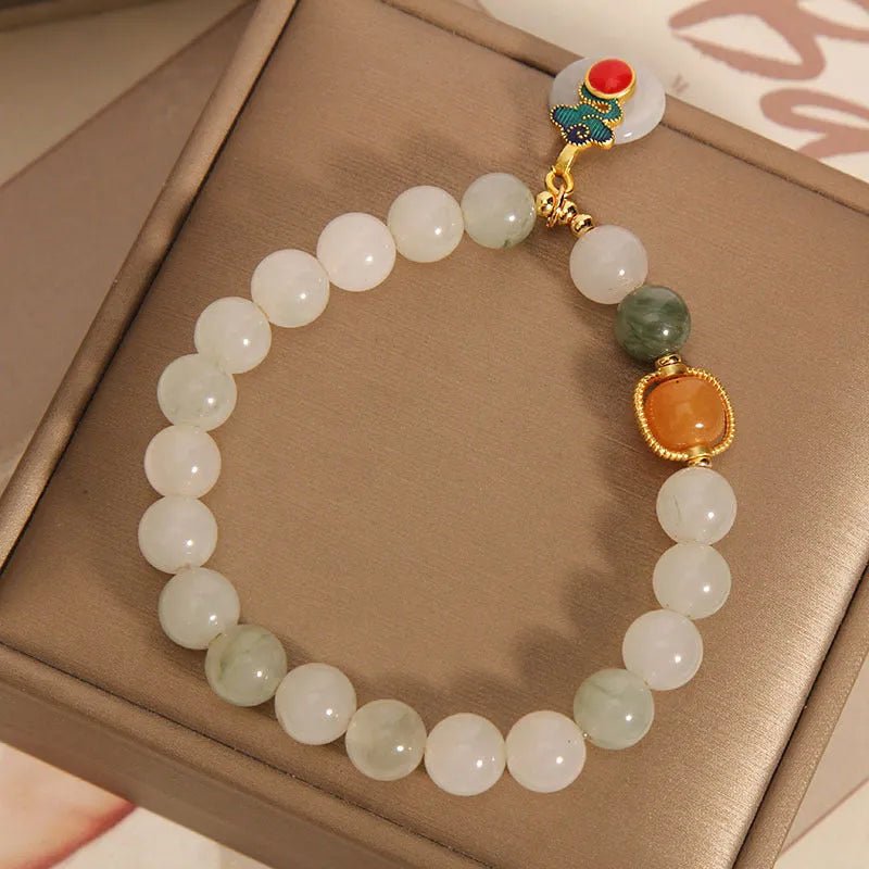 Women's ice jade crystal bracelet with a pearl detail and traditional Chinese jade buckle.