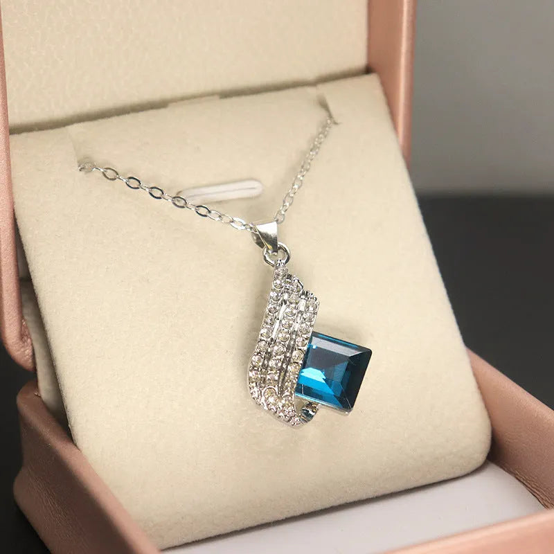 Women's necklace and earring set with glass pendant on cross chain necklace