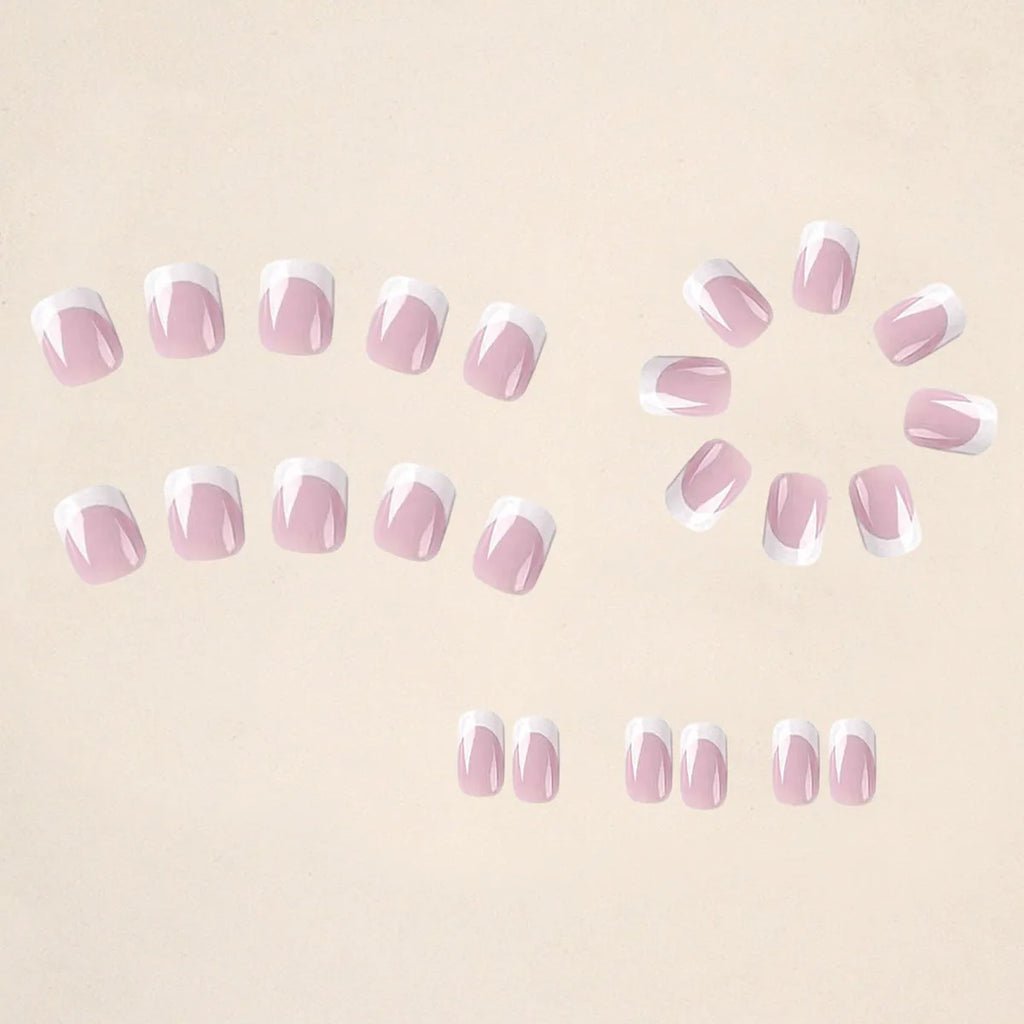 24 white acrylic nail tips with plaid pattern design arranged on display