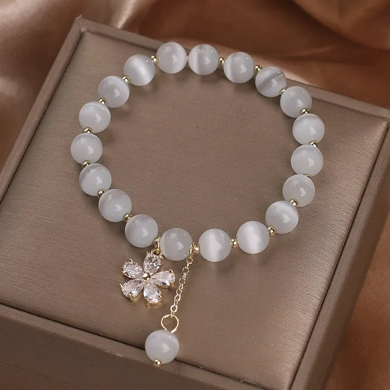Women's white cat's eye crystal bracelet with flower tassel charm and safety buckle pendant clasp