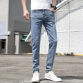 Men's Korean-style light blue tapered jeans with polyester denim blend fabric