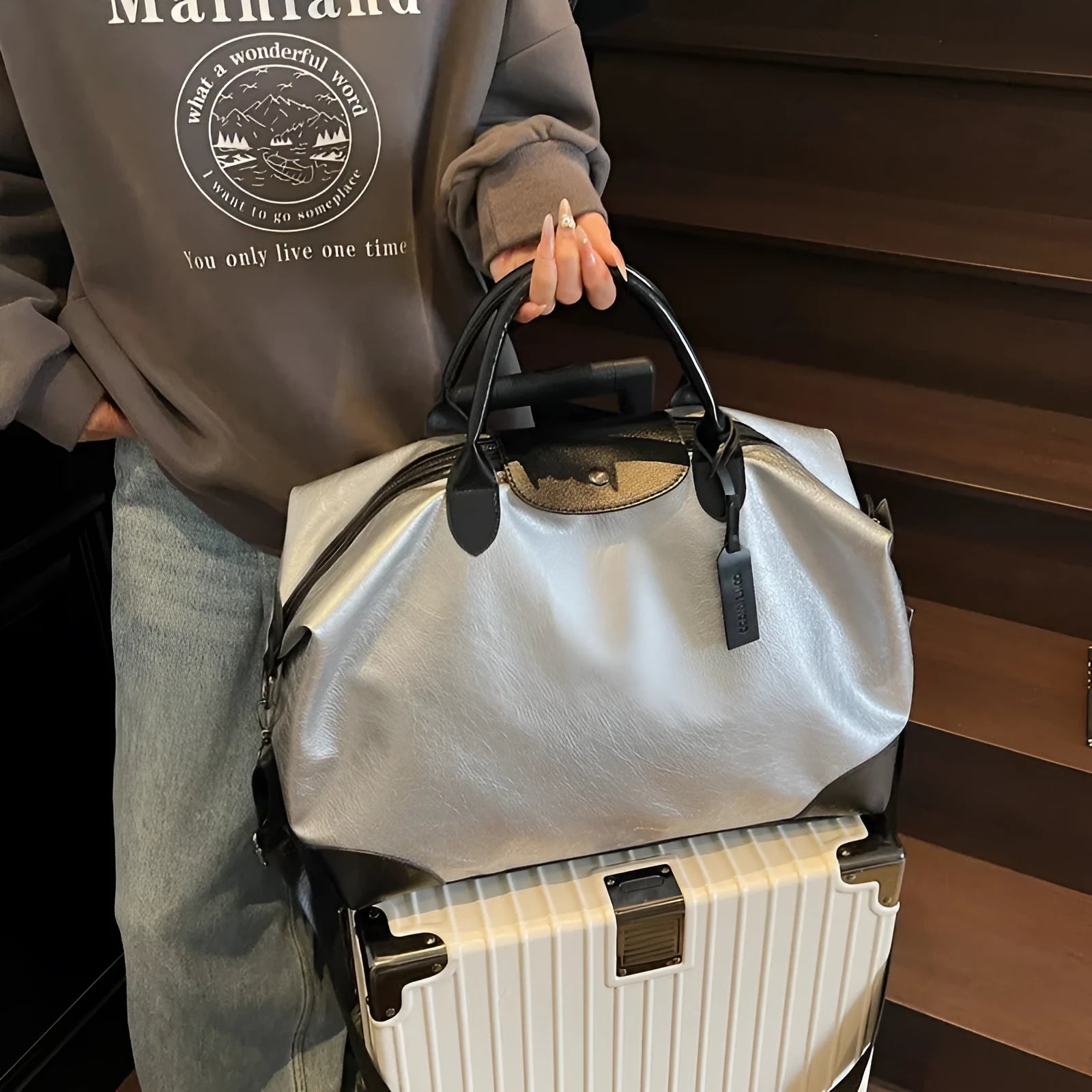 Large hand-carrying travel bag for women in black, capacity 36-55L, made from PU material with polyester lining