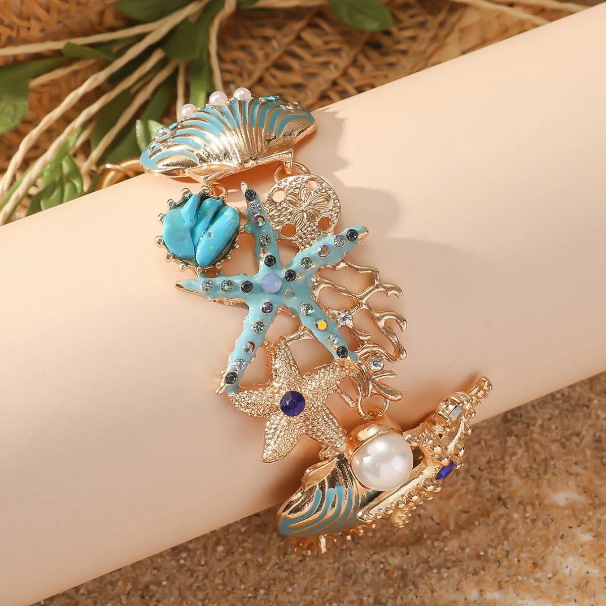 Alloy nautical bracelet with starfish, marine shell and boat anchor charms in turquoise colour