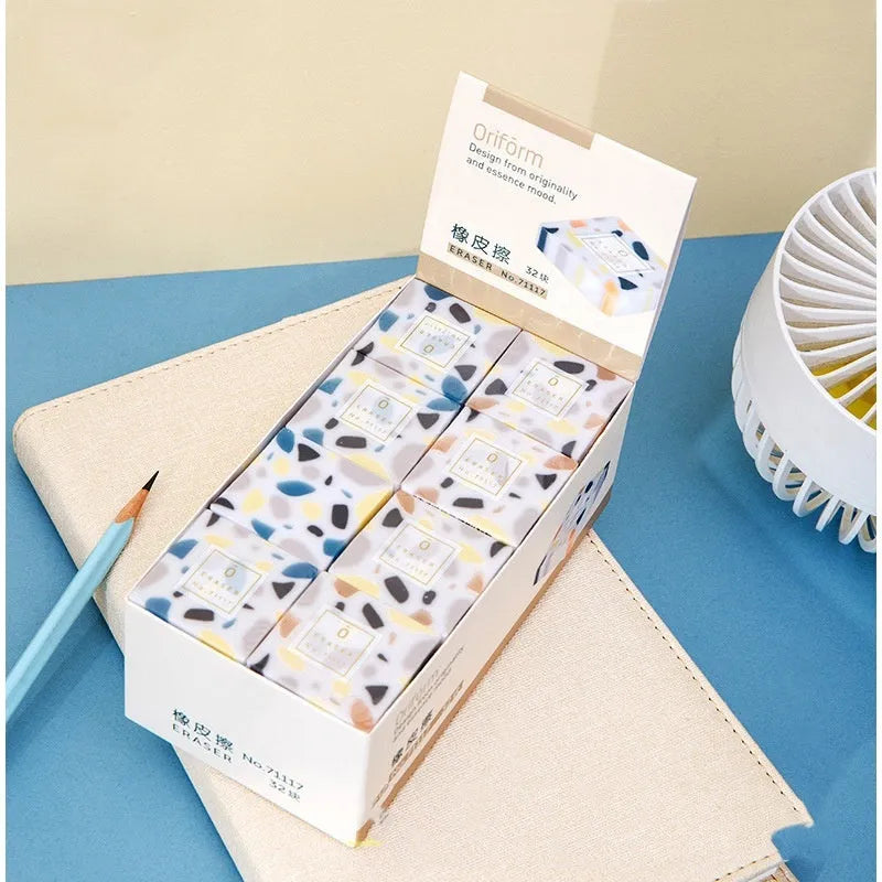 White brick-shaped rubber eraser for traceless pencil mark removal on paper