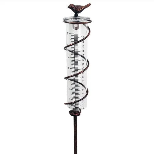 Cast iron garden rain gauge with hummingbird ornament and measurement scale.
