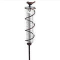 Cast iron garden rain gauge with hummingbird ornament and measurement scale.