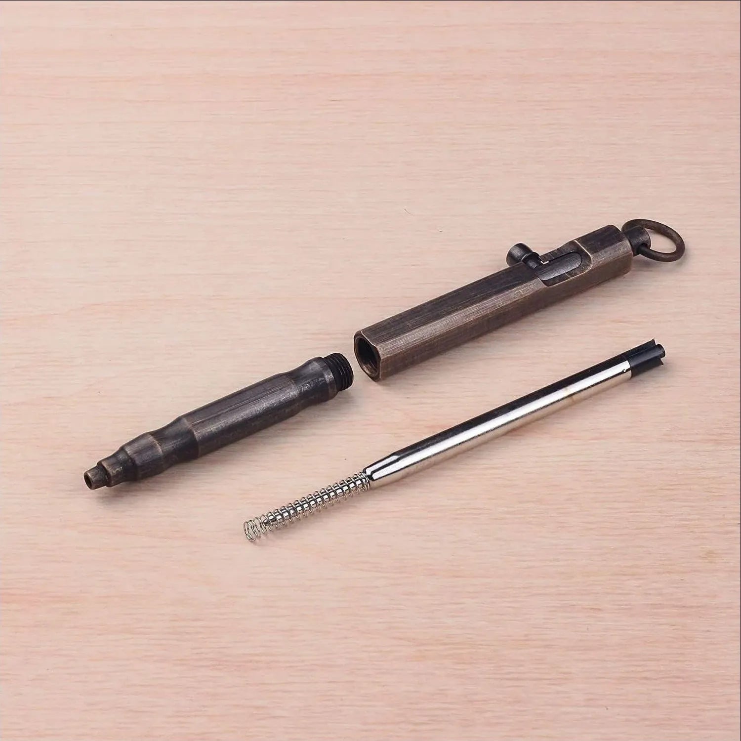 Brass hexagonal tactical pen in natural brass and retro black colours on a black gift box.