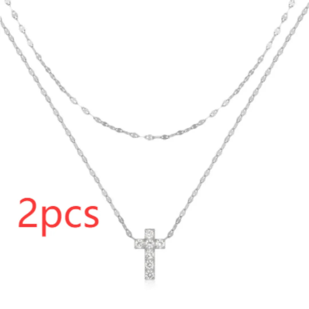 S925 sterling silver double layer twin diamond cross pendant on a clavicle chain, shown in gold and white gold finishes.